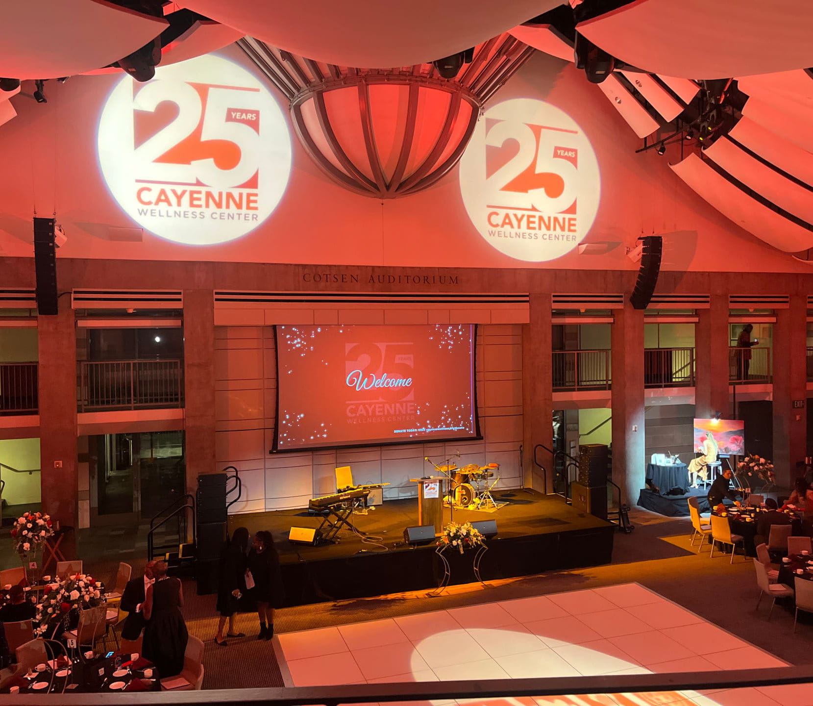 Professional audio-visual setup and large projection screen for a corporate conference main stage in a Bay Area hotel ballroom.