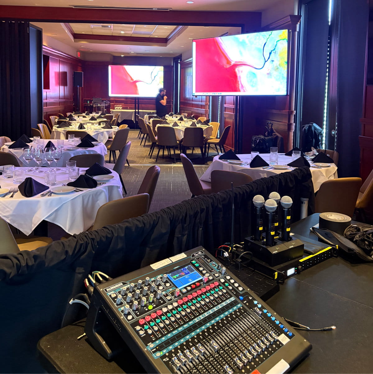 Multi-microphone panel discussion and digital sound reinforcement setup for a corporate convention breakout room.